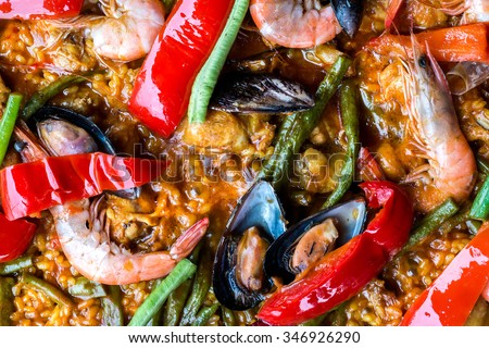 Spicy Paella with rice,shrimp,mussels,squid,olive oil,tomato,saffron,pepper,tomato and another vegetables.