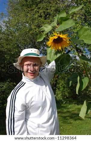Happy gardener with his great sunflower