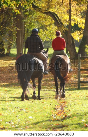 Couple riding in autumn forest