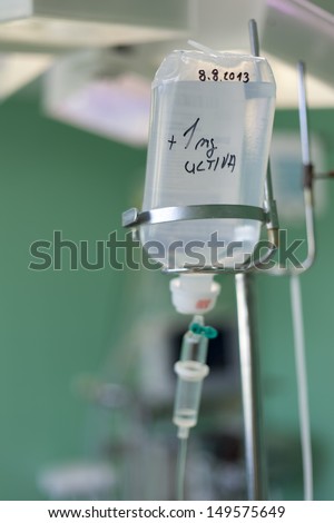 IV bag hanging on a metal pole in the room