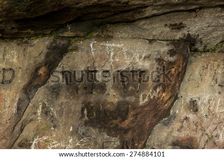 Graffiti carved into the walls of St Cuthbert\'s Cave, Northumberland, England, where medieval monks are reputed to have hid the saints body from marauding Viking\'s.