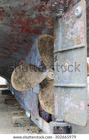 Rudder and propeller on old fishing boat.