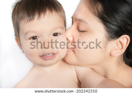 18 month old mixed race Asian boy plays happily with his Asian mom. Looking at camera