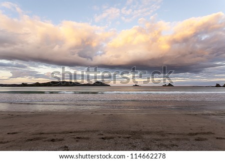 Oakura Beach, Northland, New Zealand. Beautiful sunset clouds at over one of New Zealand\'s most pretty beaches