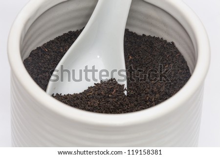 Black tea/ Loose leaf tea in a ceramic container with a matching spoon