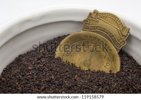 Loose leaf tea/ traditional black tea with a retro, souvenir brass tea caddy,