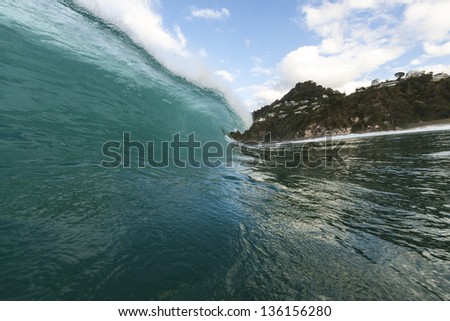 breaking wave/ a perfect surf wave pitches and tubes, shot using a water-housing