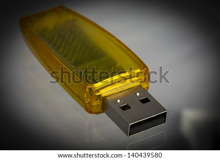 USB Stick/ a yellow clear usb stick otherwise known as a thumb drive