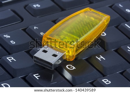 USB Stick/ a yellow clear usb stick otherwise known as a thumb drive