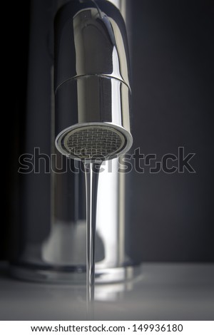 tap water/ fresh clean water flowing from a chrome tap