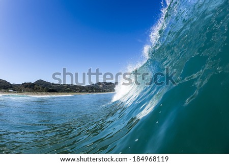 Perfect Wave/ a perfectly glassy wave pitches and tubes at North Piha Beach, New Zealand