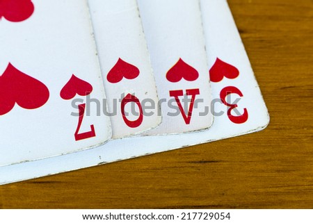 Love Cards/ The word love spelled out using the suit of Hearts out of a deck of playing cards.