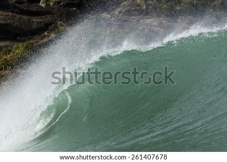 Wave Tubing/ a perfect wave tubing at Piha Beach, Auckland, New Zealand
