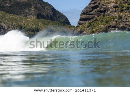 Breaking Wave/ a large wave breaks at Piha Beach, Auckland, New Zealand