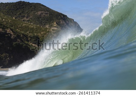 Breaking Wave/ a large wave breaks at Piha Beach, Auckland, New Zealand