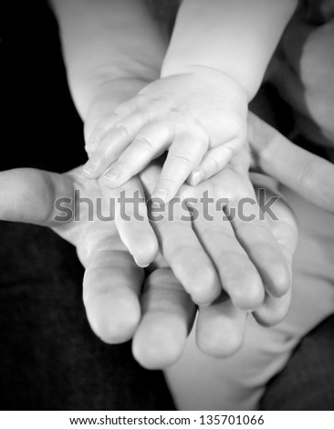 Father mother and baby holding hands family