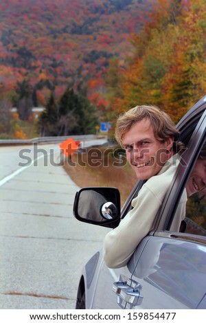 Smiling young man sitting in the car