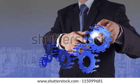 businessman hand point blue gear to success as concept businessman hand point blue gear to success as concept