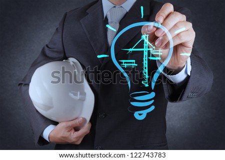 engineer drawing lightbulb and construction as concept