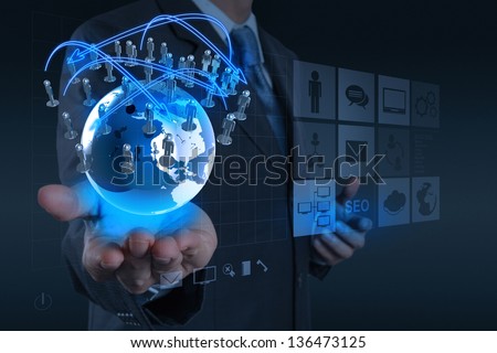 businessman hand working with new modern computer show the earth social network structure