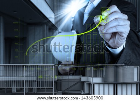 businessman hand working with new computer interface show building development concept