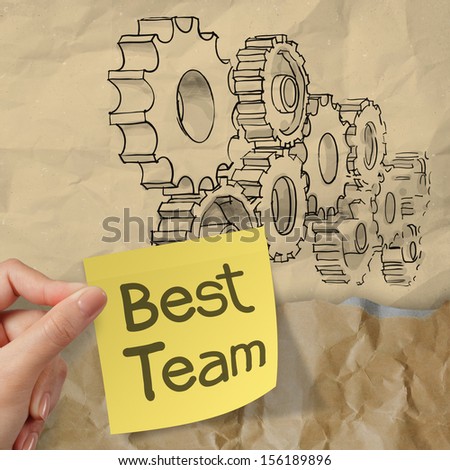 hand hold sticky note with best team word with  gear to success concept on crumpled paper as concept