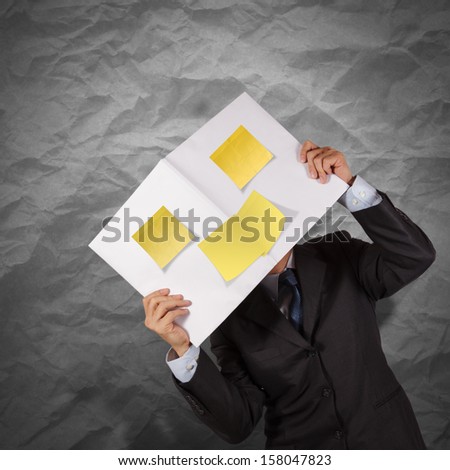 businessman hand show blank cover book and sticky note with crumpled recycle paper background