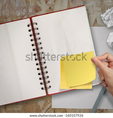 sticky notes with blank open note book on recycle wood desk top
