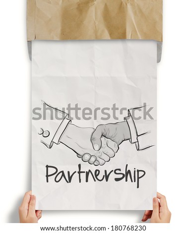 hand drawn handshake sign on crumpled paper as partnership business concept