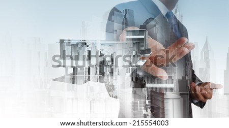 Double exposure of businessman hand presents house model on modern computer as development concept
