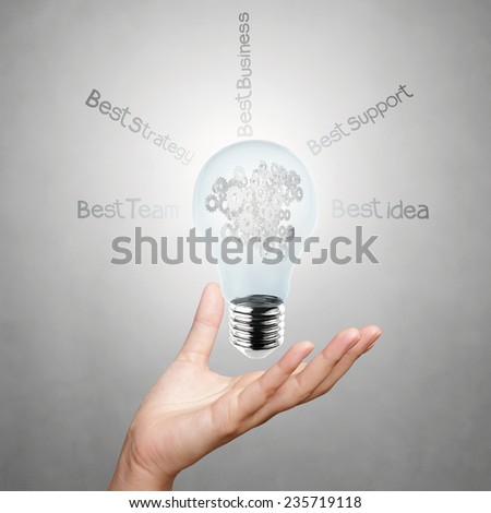 hand showing gear of creative business strategy with light bulb as concept