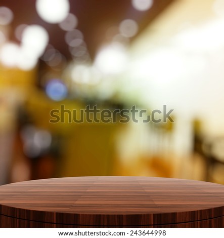 Empty wooden round table and blurred background for product presentation