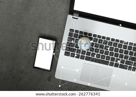 hand drawn texture globe with blank screen laptop computer and smart phone and social media diagram as internet concept on cement texture table background Elements of this image furnished by NASA