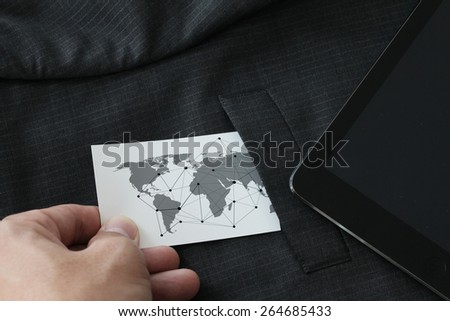 close up of businessman hand picking business card with social media diagram concept from the pocket of gray suit jacket background