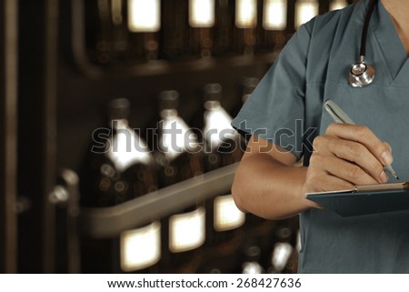 Traditional doctor working with blurred vintage bottle with bokeh background as vintage old school concept