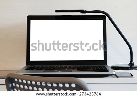 blank  screen laptop computer with table lamp is on wooden desk as workplace concept