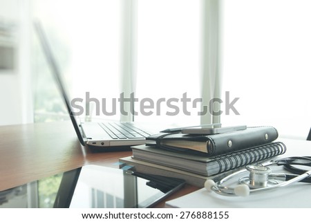 laptop computer in medical workspace office and smart phone as doctor workplace concept