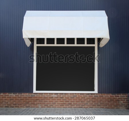 Shopfront vintage store front with canvas awnings and blank display