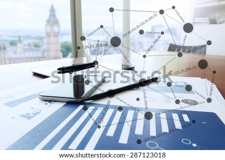 business documents on office table with smart phone and digital tablet as workspace business with blank screen computer laptop with social media diagram
