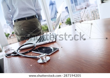 Doctor working with laptop computer in medical workspace office and medical network media diagram as concept