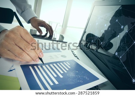 business documents on office table with smart phone and digital tablet and graph business diagram and man working in the background and social media diagram