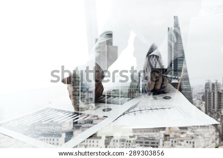 Double exposure of businessman working with new modern computer  and london city blurred background