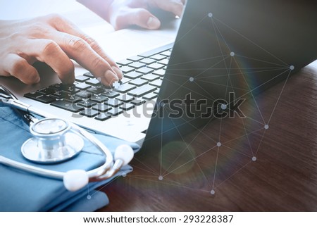 Doctor hand working with laptop computer in medical workspace office as concept with social media diagram