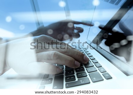 Double exposure of business man hand working on blank screen laptop computer on wooden desk as concept