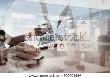 double exposure of  business man hand working on laptop computer on wooden desk as concept