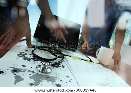 double exposure of doctor working with digital tablet and laptop computer in medical workspace office and medical network media diagram as concept