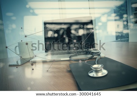 Doctor workspace with laptop computer in medical workspace office and medical network media diagram as concept