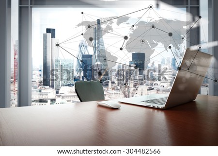 Office workplace with laptop and smart phone on wood table with london city background with social media diagram