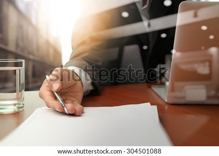 double exposure of businessman or salesman handing over a contract on wooden desk