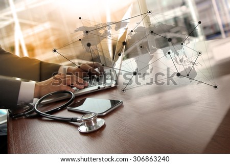 Doctor working at workspace with laptop computer in medical workspace office and medical network media diagram as concept